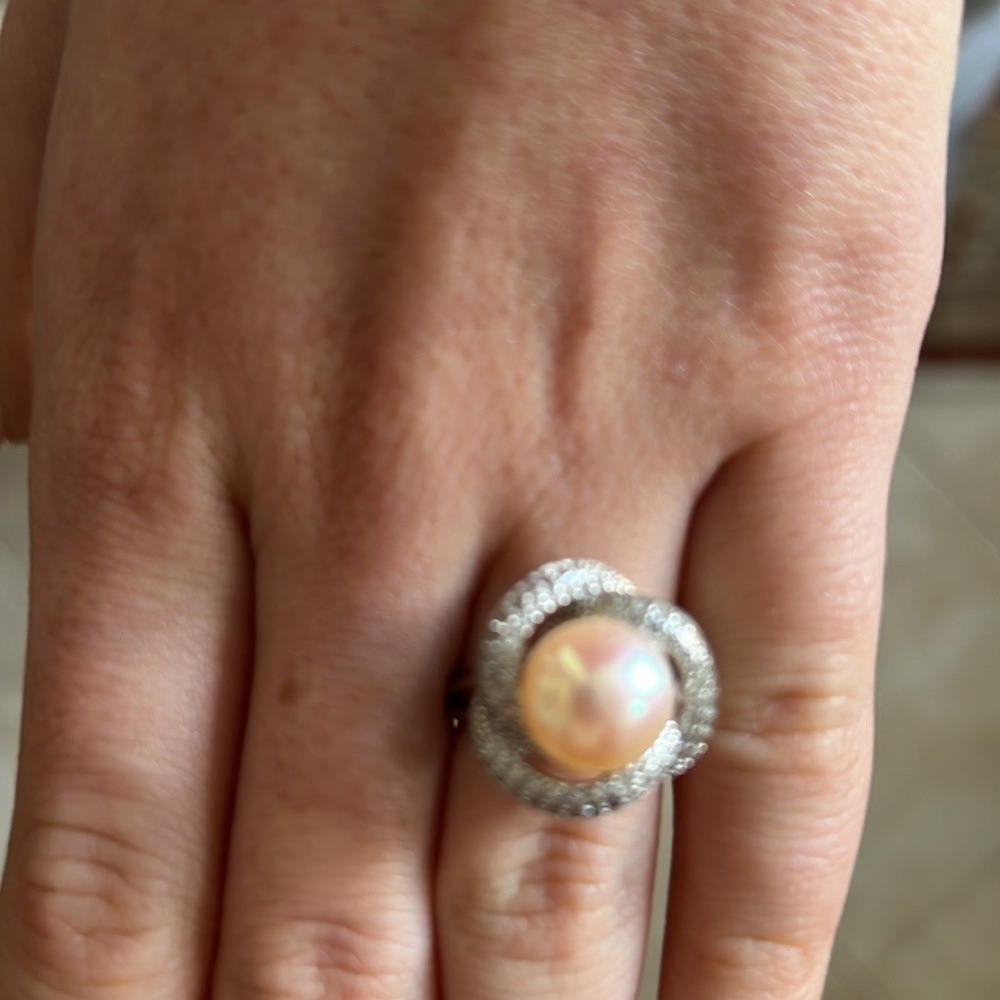Crystals adorn a silver petal ring that frames an elegant center cultured pearl.